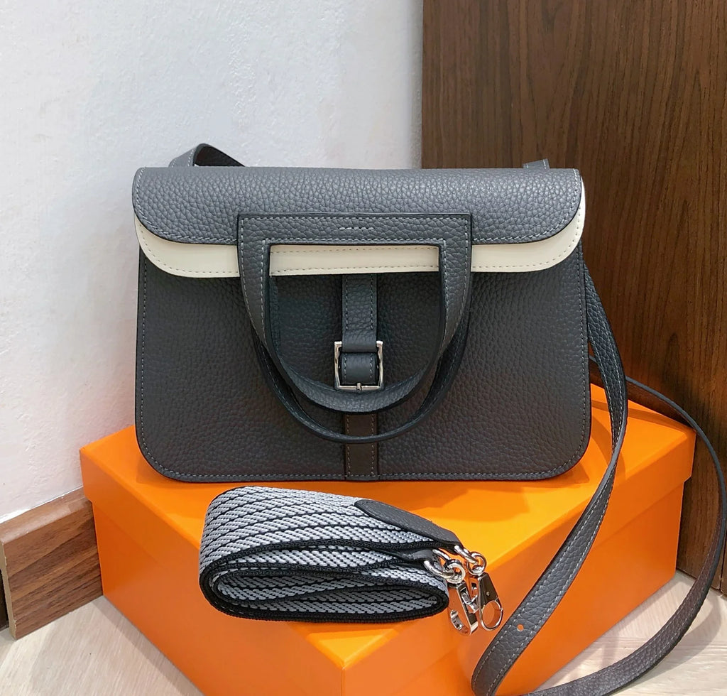 Halzan 25 features a design with graphite grey and white leather accents silver hardware