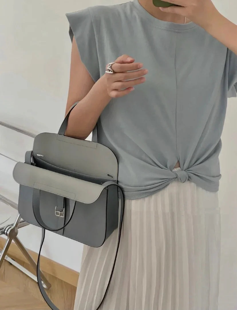 Halzan 25 features a design with graphite grey and white leather accents silver hardware