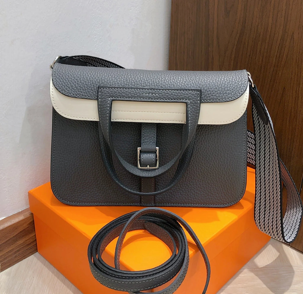 Halzan 25 features a design with graphite grey and white leather accents silver hardware