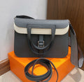 Halzan 25 features a design with graphite grey and white leather accents silver hardware